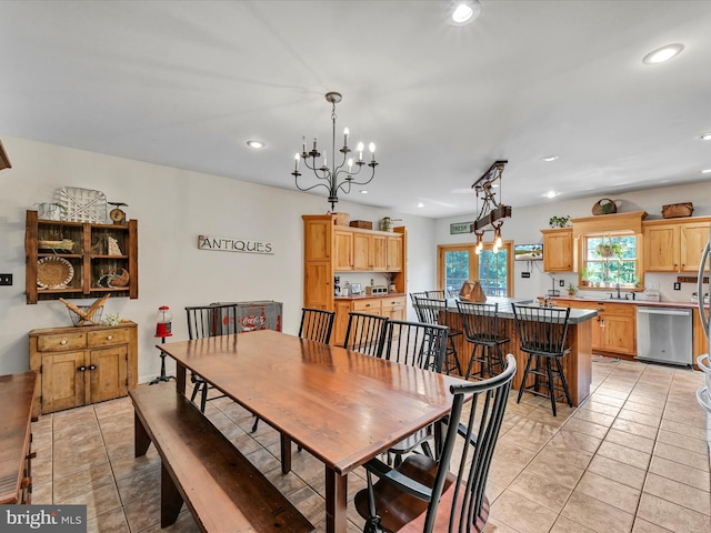 tiled dining room with sink and a chandelier