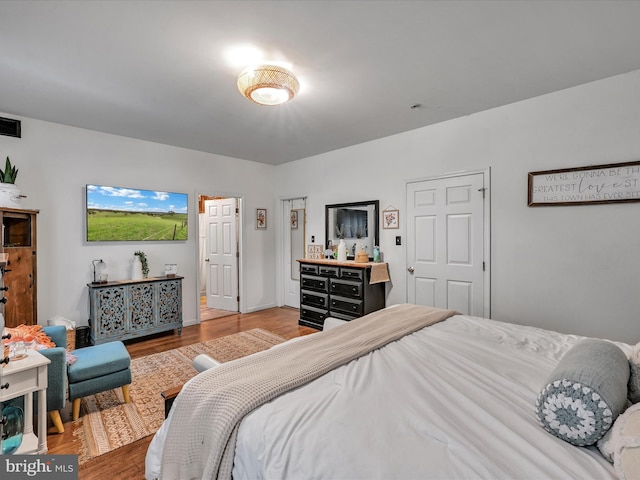 bedroom with hardwood / wood-style floors