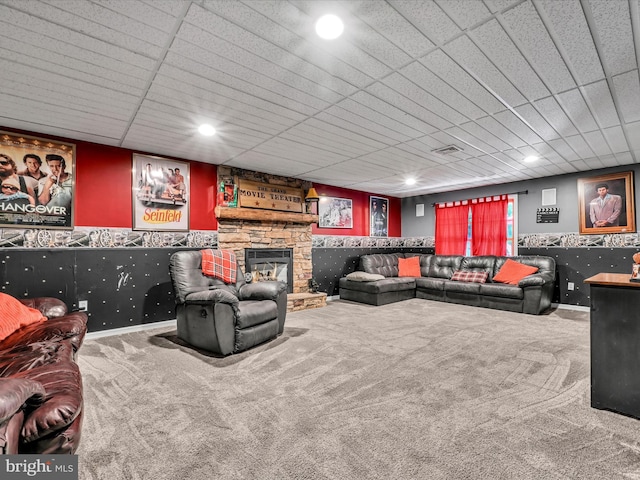 interior space featuring carpet, a paneled ceiling, and a fireplace