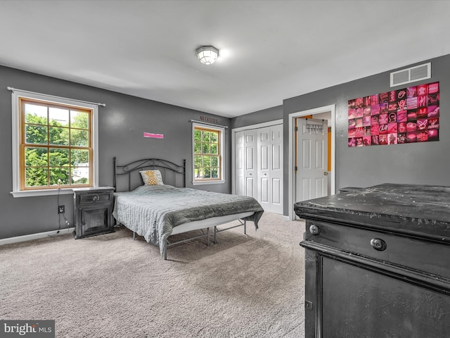 carpeted bedroom with a closet