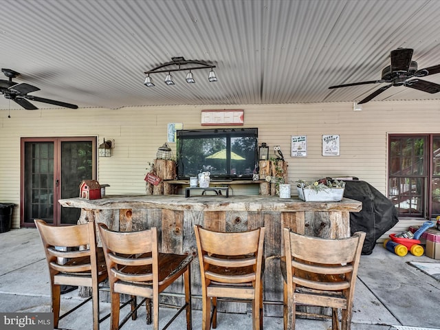 view of patio featuring ceiling fan and an outdoor bar