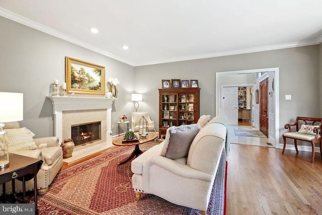 living room with wood-type flooring and ornamental molding