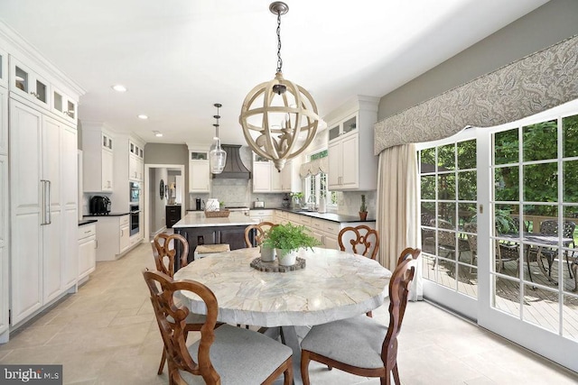 dining area with a notable chandelier and sink