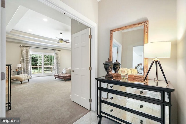 bedroom featuring access to exterior, crown molding, a raised ceiling, and light carpet