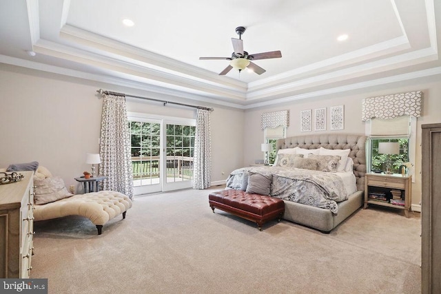 bedroom featuring light carpet, access to outside, a tray ceiling, and ceiling fan