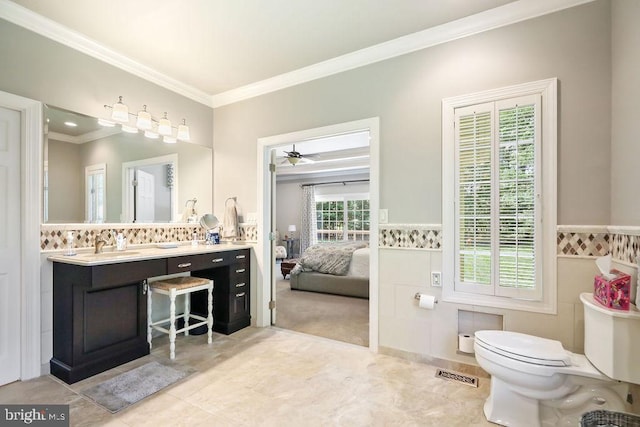 bathroom featuring vanity, tile patterned floors, ceiling fan, toilet, and ornamental molding