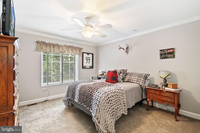 bedroom with light colored carpet, ceiling fan, and crown molding