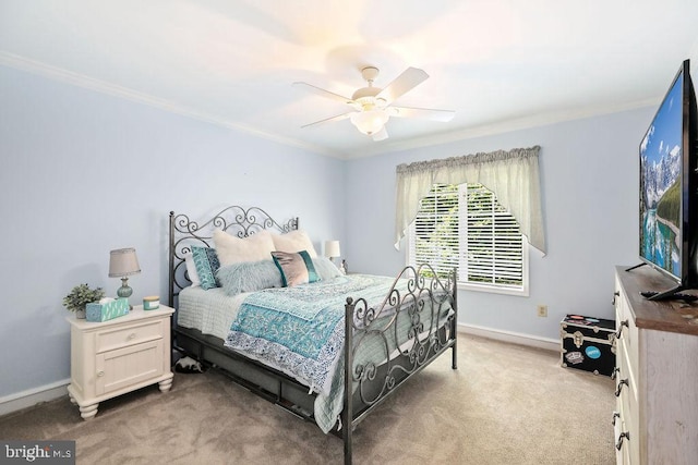 carpeted bedroom with ceiling fan and ornamental molding