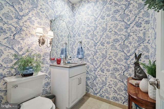 bathroom featuring tile patterned floors, vanity, and toilet