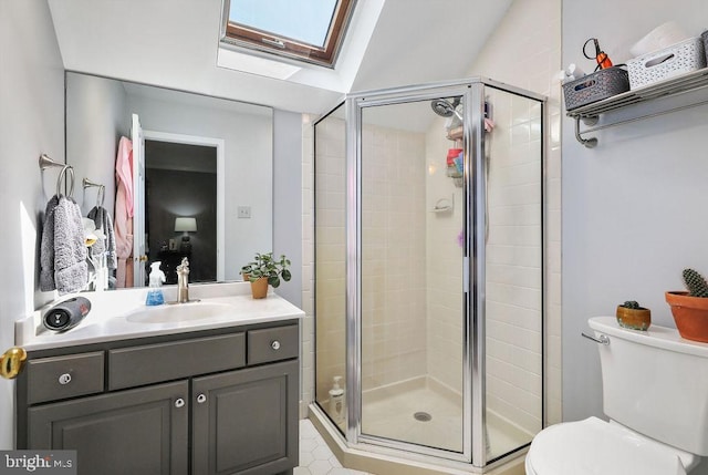 bathroom with toilet, vanity, lofted ceiling with skylight, and walk in shower