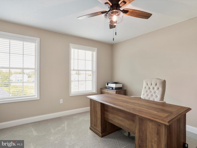 office space with ceiling fan and light carpet