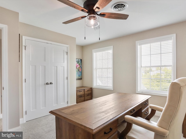 office space featuring ceiling fan and light carpet