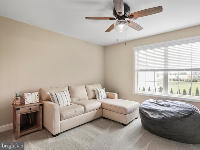 carpeted living room with ceiling fan