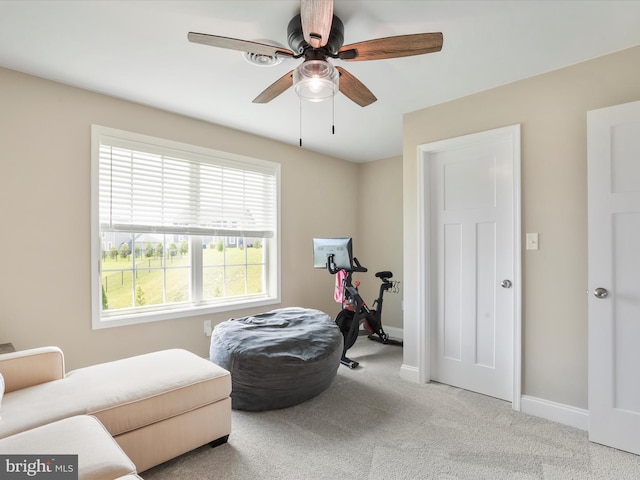 sitting room featuring light carpet and ceiling fan