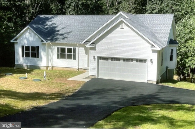 view of front facade with a front yard and a garage