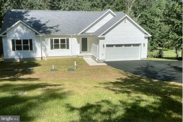 view of front of house with a front lawn and a garage