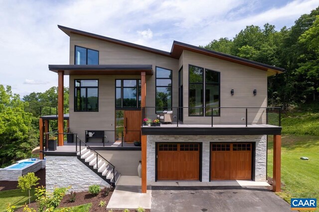 225 Cherry Ridge Ln, Lexington, VA 24450 - view of front facade featuring an attached garage, driveway, a front lawn, stairs, and stone siding