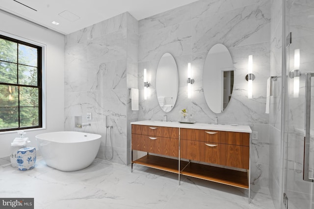 bathroom featuring separate shower and tub, vanity, and tile walls