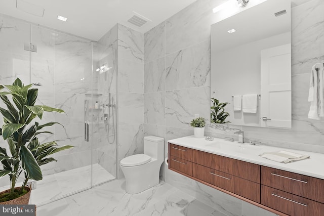 bathroom with a shower with door, vanity, tile walls, and toilet