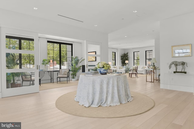 dining room with elevator and light wood-type flooring