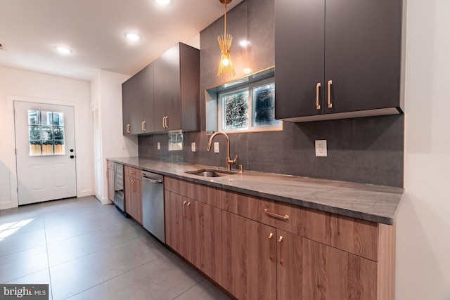 kitchen with dark stone counters, sink, stainless steel dishwasher, tasteful backsplash, and decorative light fixtures