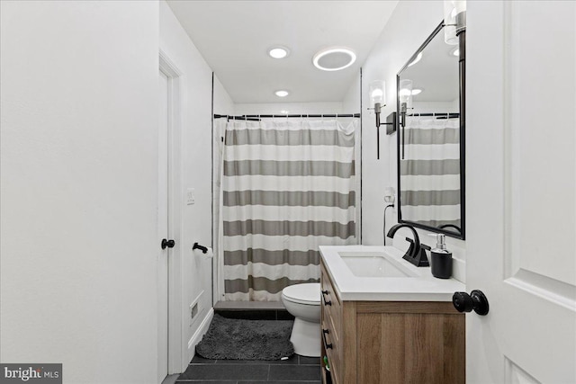 bathroom with tile patterned floors, vanity, and toilet