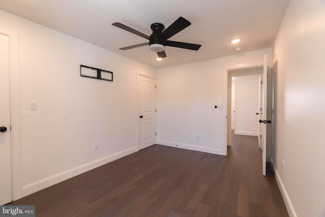 unfurnished bedroom featuring ceiling fan and dark hardwood / wood-style flooring