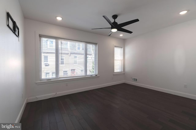 empty room featuring ceiling fan and dark hardwood / wood-style flooring