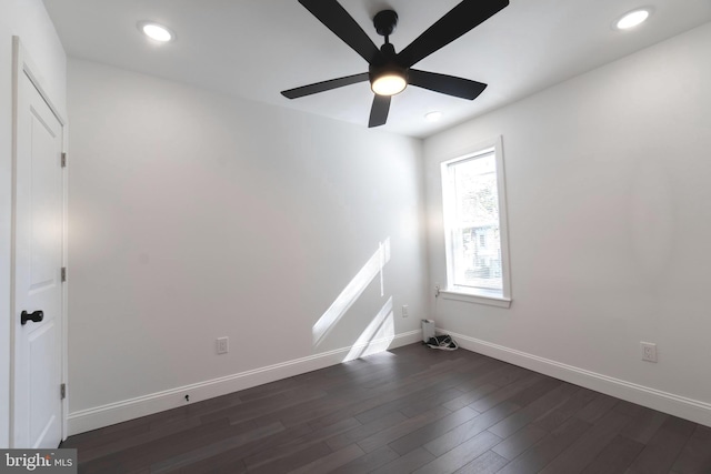 empty room with ceiling fan and dark hardwood / wood-style floors