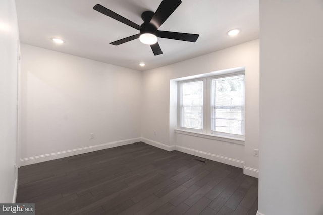 spare room featuring ceiling fan and dark hardwood / wood-style floors