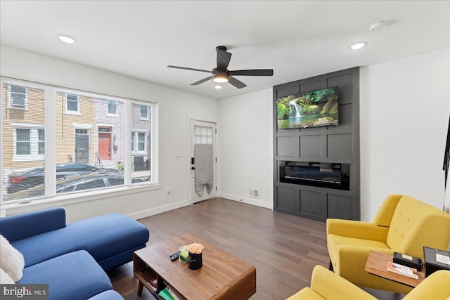 living room featuring dark hardwood / wood-style floors and ceiling fan