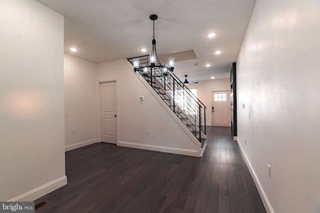 interior space with dark hardwood / wood-style flooring and an inviting chandelier