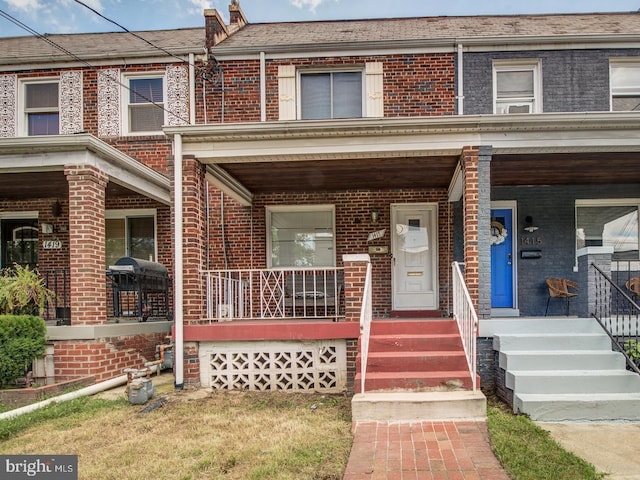 townhome / multi-family property with covered porch