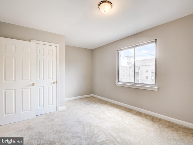 unfurnished bedroom with a closet and carpet