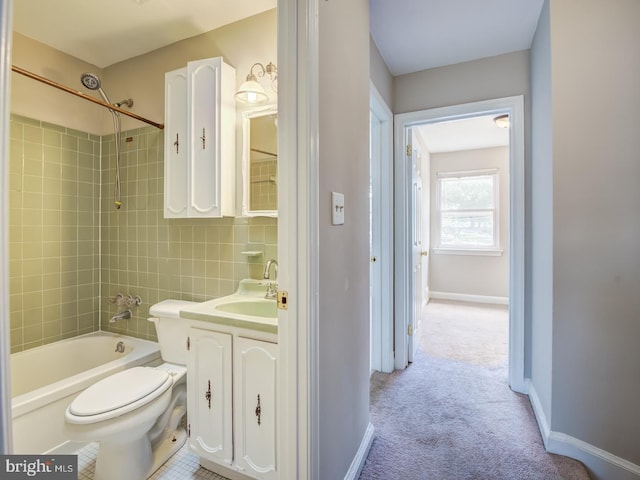 full bathroom featuring vanity, toilet, tiled shower / bath combo, and tasteful backsplash