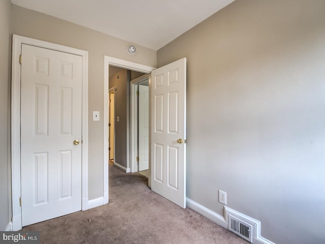 unfurnished bedroom featuring light colored carpet