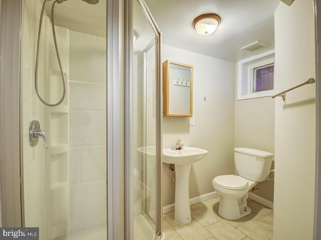 bathroom featuring tile patterned flooring, toilet, and an enclosed shower