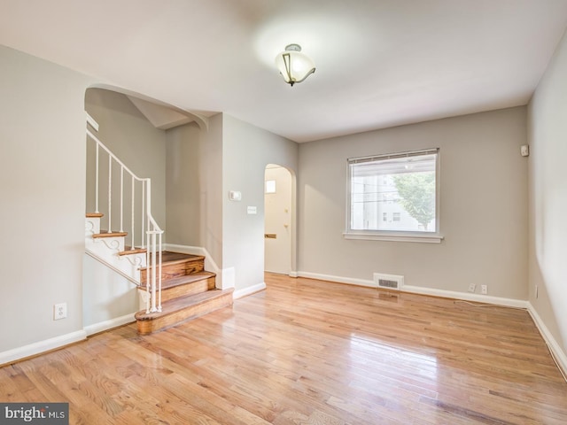 unfurnished room with light wood-type flooring