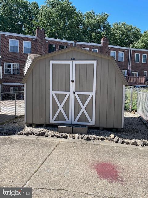 view of shed with fence