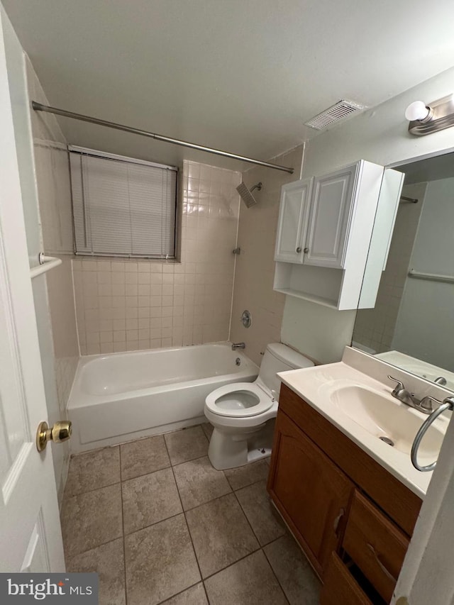 full bathroom with toilet, tile patterned flooring, vanity, and tiled shower / bath