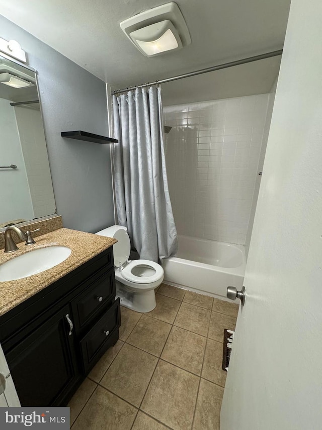 full bathroom with tile patterned floors, shower / bath combo, toilet, and vanity