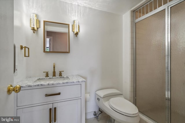 bathroom with tile patterned floors, vanity, toilet, and walk in shower