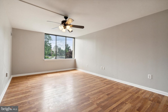 unfurnished room with ceiling fan and wood-type flooring