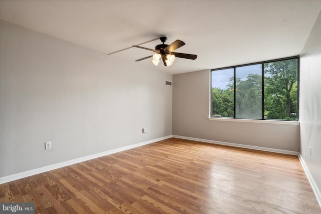 empty room with light hardwood / wood-style floors and ceiling fan