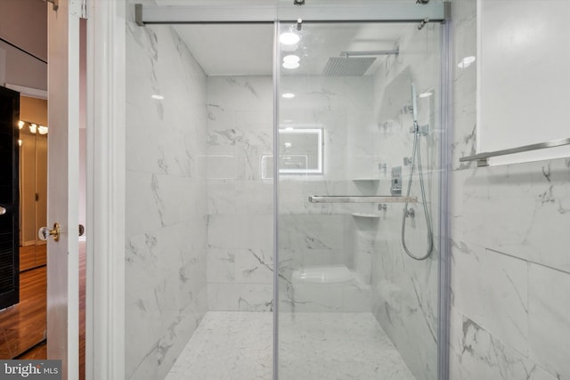 bathroom with a shower with shower door