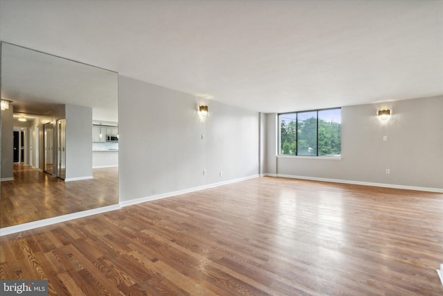 empty room with hardwood / wood-style floors