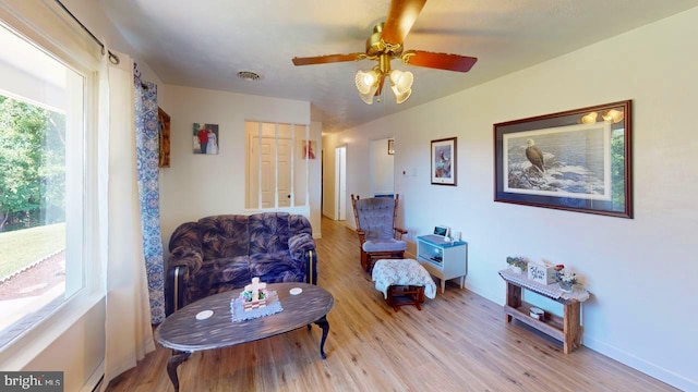 living area featuring ceiling fan and light hardwood / wood-style flooring