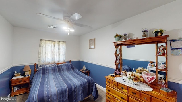 bedroom with ceiling fan and dark wood-type flooring