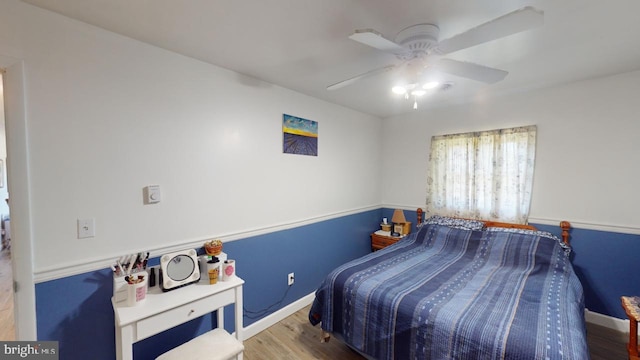 bedroom featuring hardwood / wood-style flooring and ceiling fan