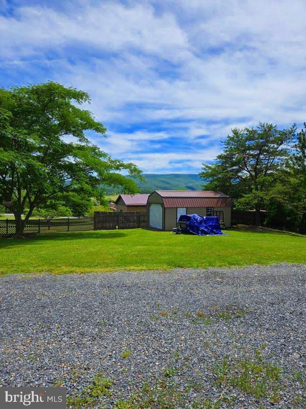 exterior space with a garage and an outbuilding